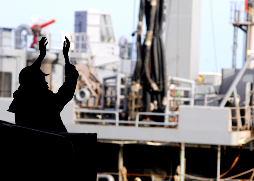 Flickr - Official U.S. Navy Imagery - A Sailor signals to civilian mariners aboard USS Abraham Lincoln.