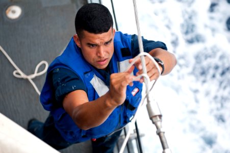 Flickr - Official U.S. Navy Imagery - A Sailor ties a tarp to cover the quarterdeck.