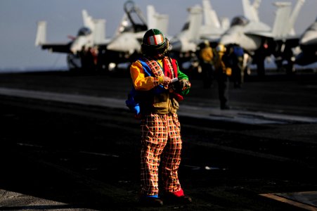 Flickr - Official U.S. Navy Imagery - A Sailor wears a clown suit while launching aircraft.