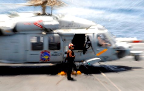 Flickr - Official U.S. Navy Imagery - A Sailor stands by to remove chocks and chains from a helicopter.