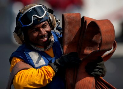 Flickr - Official U.S. Navy Imagery - A Sailor stows hoses after flight deck firefighting drills.