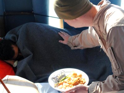 Flickr - Official U.S. Navy Imagery - A U.S. Coast Guardsman offers food to an Iranian mariner.