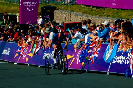 Flickr - Official U.S. Navy Imagery - A U.S. Navy veteran and 2012 U.S. Paralympic road cyclist rides past fans.