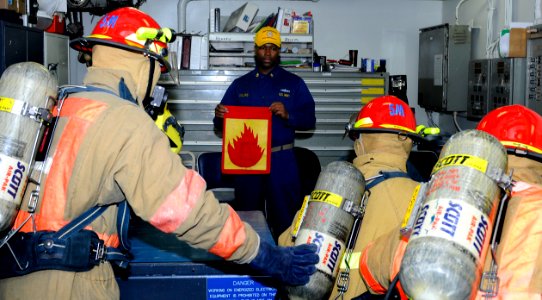 Flickr - Official U.S. Navy Imagery - Damage control training team member holds a flag symbolizing a class alpha fire.