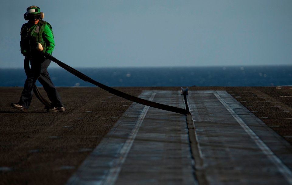 Flickr - Official U.S. Navy Imagery - ABEAN Reyes removes rubber seals from the bow catapults prior to flight operations