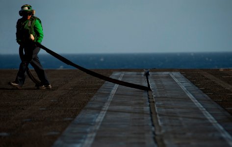Flickr - Official U.S. Navy Imagery - ABEAN Reyes removes rubber seals from the bow catapults prior to flight operations