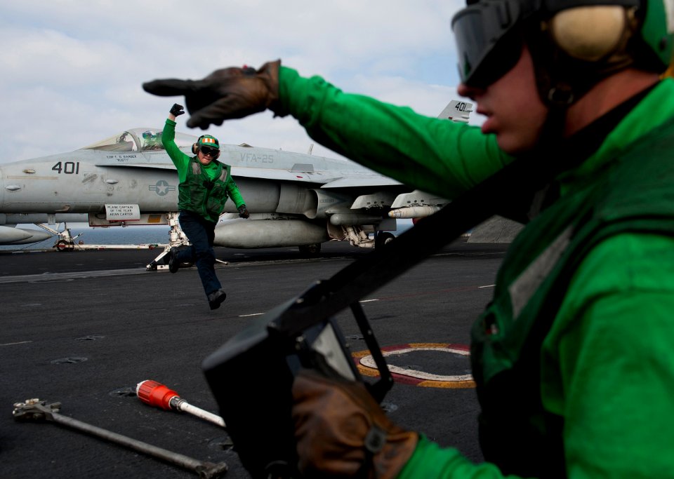 Flickr - Official U.S. Navy Imagery - Air department personnel clear the launch area after readying a catapult to launch.