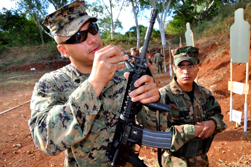 Flickr - Official U.S. Navy Imagery - An El Salvadoran Marine adjust the front sight on a rifle.