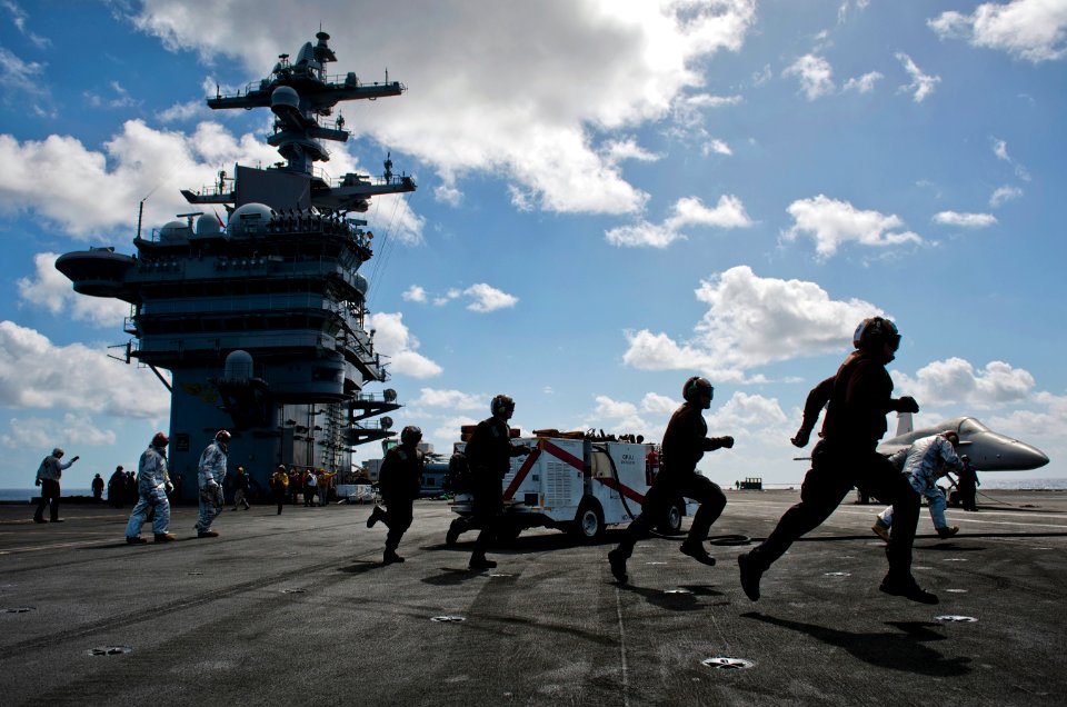Flickr - Official U.S. Navy Imagery - Flight deck personnel run to man hose teams and combat a simulated aircraft fire