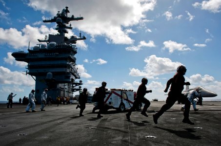Flickr - Official U.S. Navy Imagery - Flight deck personnel run to man hose teams and combat a simulated aircraft fire
