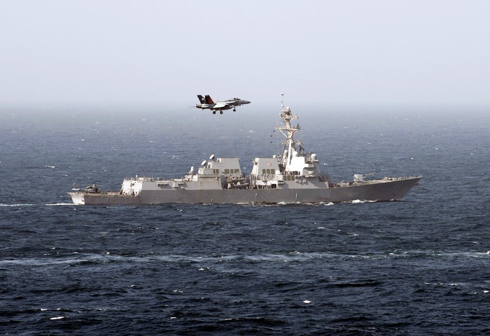 Flickr - Official U.S. Navy Imagery - An F-A-18E Super Hornet assigned to Strike Fighter Squadron (VFA) 81 passes the Arleigh Burke-class guided-missile destroyer USS Momsen.