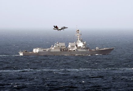 Flickr - Official U.S. Navy Imagery - An F-A-18E Super Hornet assigned to Strike Fighter Squadron (VFA) 81 passes the Arleigh Burke-class guided-missile destroyer USS Momsen.