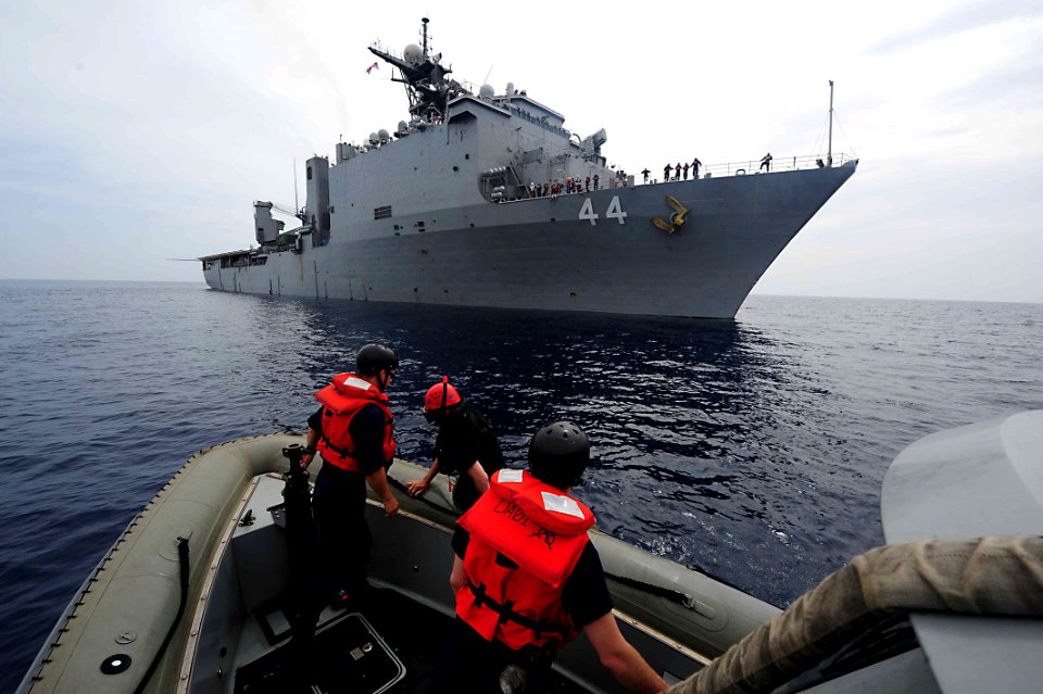 Flickr - Official U.S. Navy Imagery - Boatswain Mate 3rd Class Michael Kenyon prepares to get lowered from the amphibious dock-landing ship USS Gunston Hall.