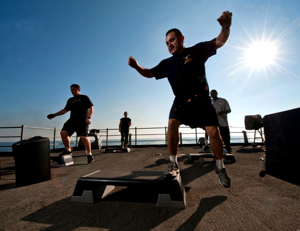 Flickr - Official U.S. Navy Imagery - Chief Aircrew Survival Equipmentman Jose Castillo, a fitness instructor, leads a step aerobics class on the fantail of the Nimitz-class aircraft carrier USS Carl Vinson.