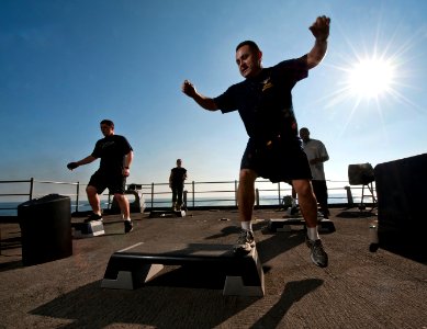 Flickr - Official U.S. Navy Imagery - Chief Aircrew Survival Equipmentman Jose Castillo, a fitness instructor, leads a step aerobics class on the fantail of the Nimitz-class aircraft carrier USS Carl Vinson.