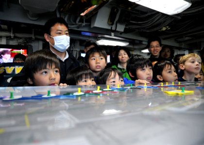 Flickr - Official U.S. Navy Imagery - Kids peer over the Ouija board.