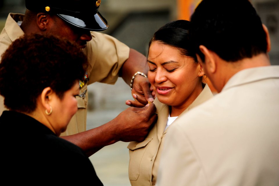 Flickr - Official U.S. Navy Imagery - Chief Ship's Serviceman Angela A. Zamora, assigned to USS Wasp (LHD 1), gets her anchors pinned on by her family and a mentor after a meritorious promotion to the rank of chief petty officer.