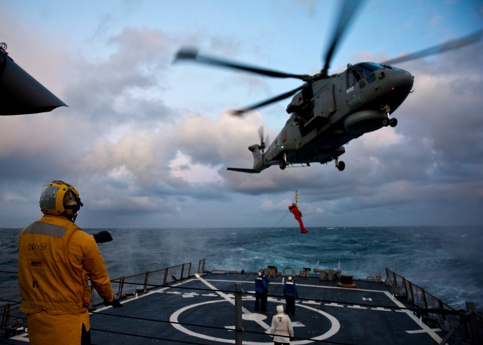 Flickr - Official U.S. Navy Imagery - Boatswain's Mate 2nd Class Brendon Braveboy signals a Royal Navy HM MK 1 Merlin helicopter to approach the flight deck of USS Arleigh Burke (DDG 51).