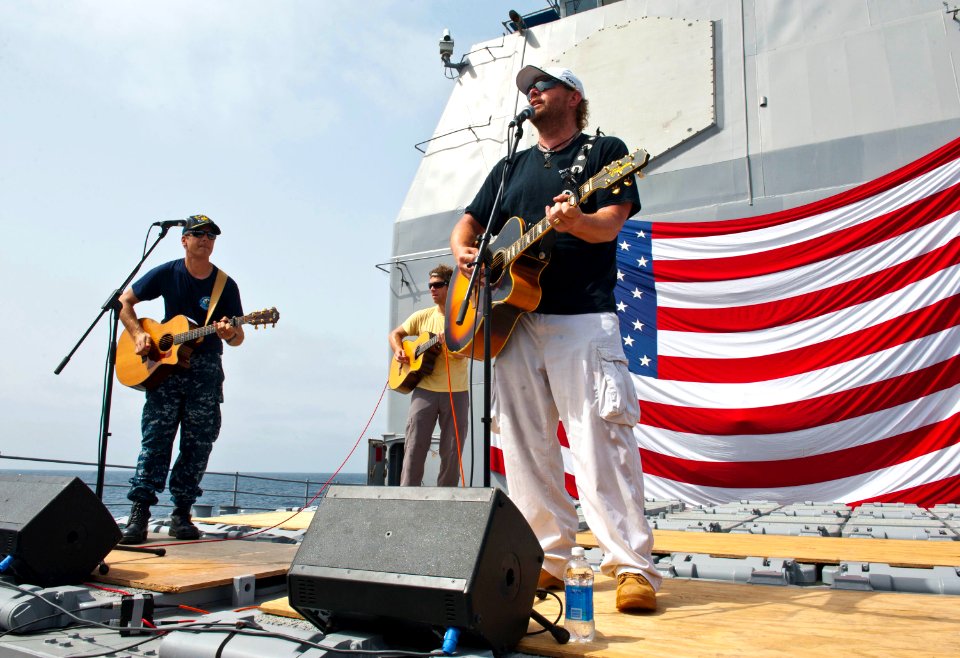 Flickr - Official U.S. Navy Imagery - CO of USS Cape St. George performs with country music singer Toby Keith during a USO performance.
