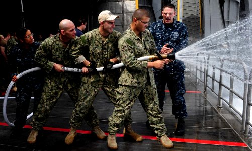 Flickr - Official U.S. Navy Imagery - Culinary Specialist 2nd Class Howard LeRoy explains proper hose-handling techniques to Sailors during damage control training.