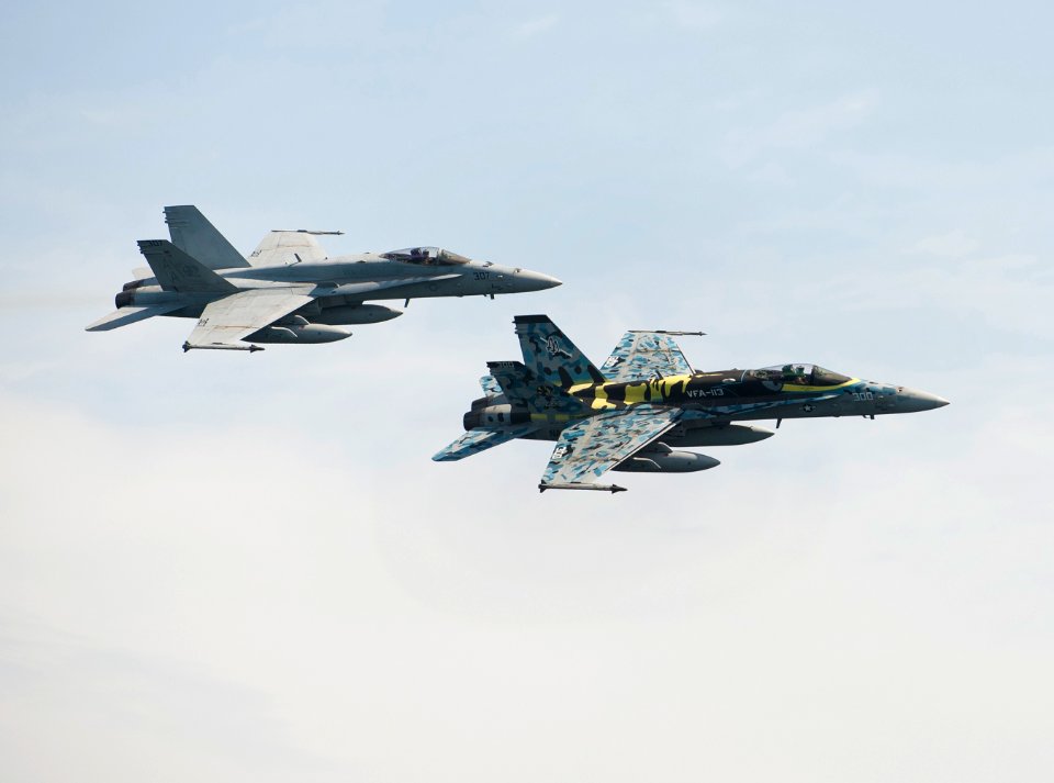 Flickr - Official U.S. Navy Imagery - F-A-18C Hornets fly over the Nimitz-class aircraft carrier USS Carl Vinson.