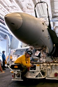 Flickr - Official U.S. Navy Imagery - Huntington Beach native-Sailor maneuvers an F-A-18C Hornet in the hangar bay of USS John C. Stennis