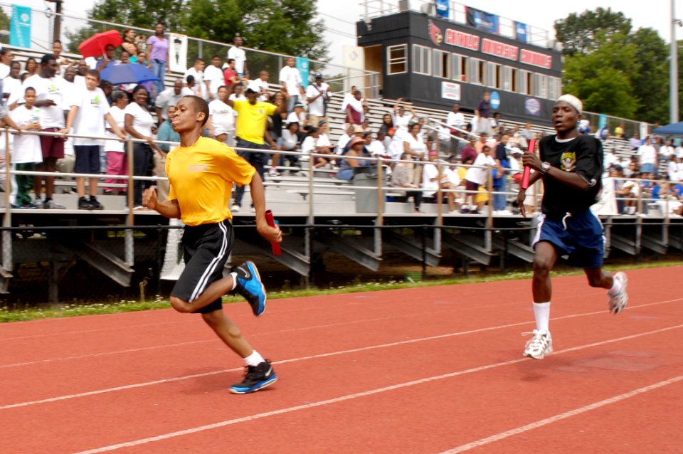 Flickr - Official U.S. Navy Imagery - Runners at the 2012 Washington D.C. Special Olympics represent the U.S. Navy and Army during a 4x100 meter relay race at the 2012 Washington D.C. Special Olympics.