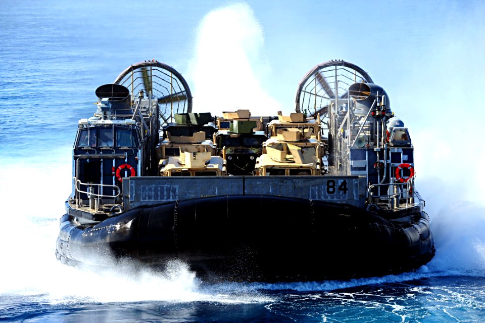 Flickr - Official U.S. Navy Imagery - Landing Craft Air Cushion (LCAC) 84 approaches the amphibious dock landing ship USS Gunston Hall.