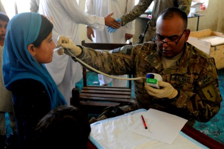 Flickr - Official U.S. Navy Imagery - HMSN Colon assigned to Naval Hospital Okinawa, Japan, checks a girl’s temperature