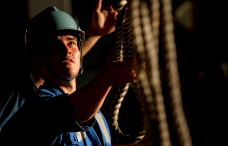 Flickr - Official U.S. Navy Imagery - Sailor clears lines from pallets of stores as they arrive in hangar.