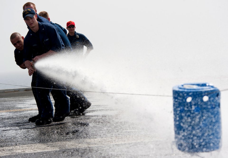 Flickr - Official U.S. Navy Imagery - Hull Maintenance Technician leads hose team in fire hose race aboard USS Carl Vinson.