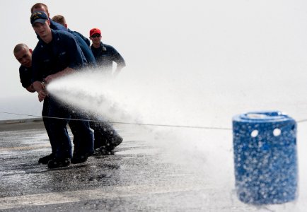 Flickr - Official U.S. Navy Imagery - Hull Maintenance Technician leads hose team in fire hose race aboard USS Carl Vinson.