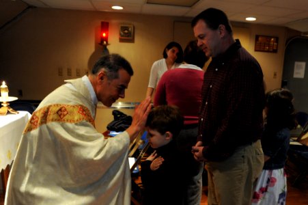 Flickr - Official U.S. Navy Imagery - Lt. Cmdr. Jose Pimentel blesses a child during an Easter Sunday Mass.
