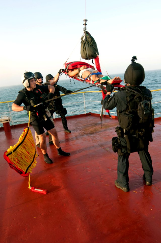 Flickr - Official U.S. Navy Imagery - Medical and rescue personnel assist in airlifting an injured crew member.