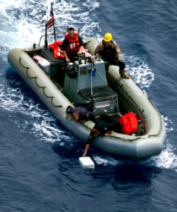 Flickr - Official U.S. Navy Imagery - Navy and Coast Guard personnel pick up bales of narcotics during recovery operations in the Caribbean Sea.