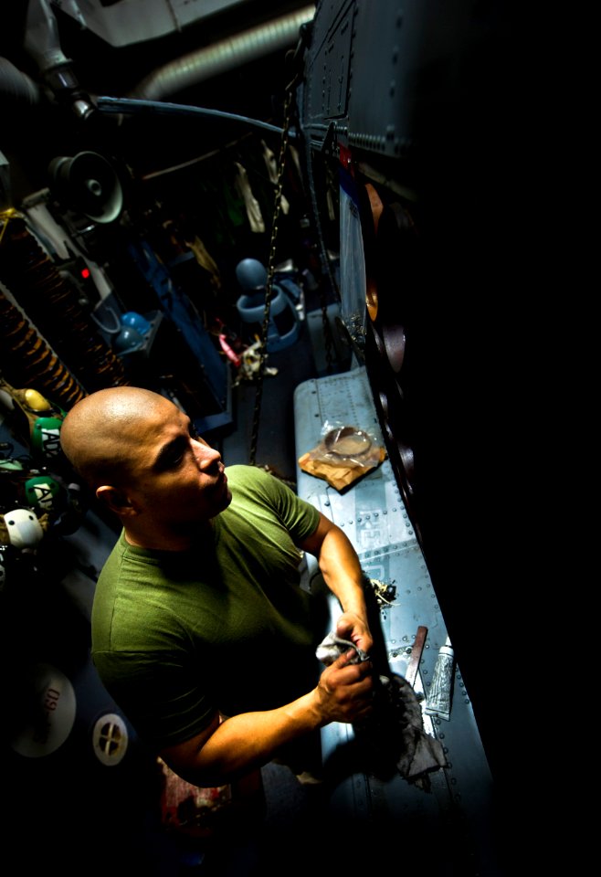 Flickr - Official U.S. Navy Imagery - Sailor performs maintenance on a helicopter.