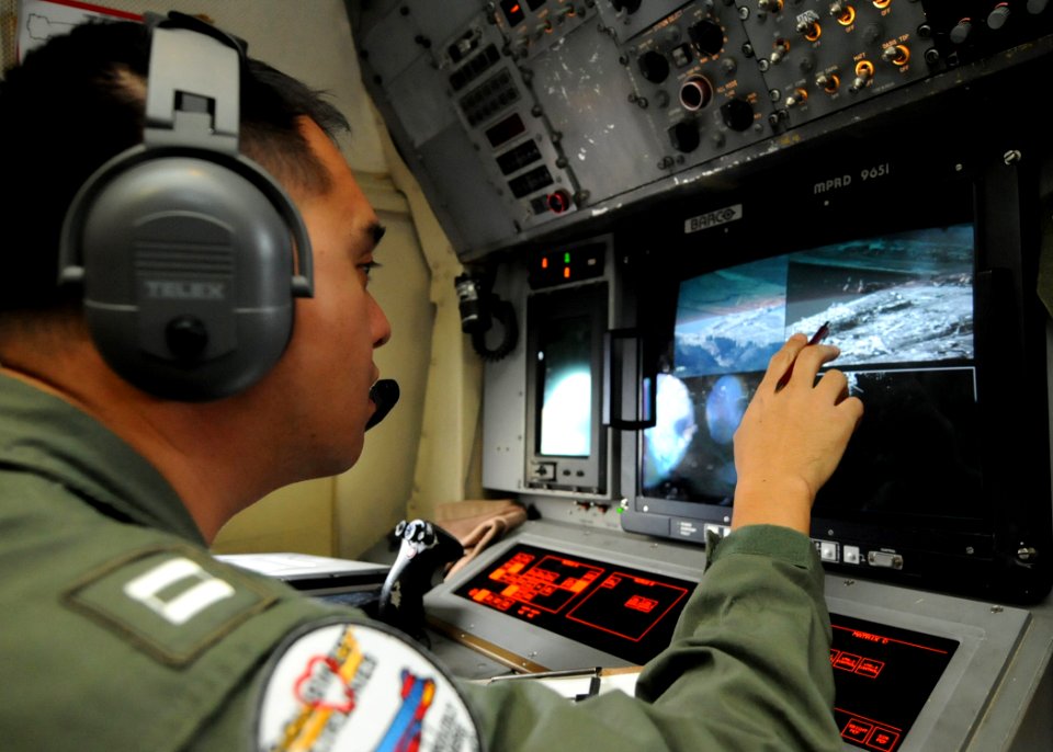 Flickr - Official U.S. Navy Imagery - Sailor reviews aerial images of northeast Japan during survey of the region.