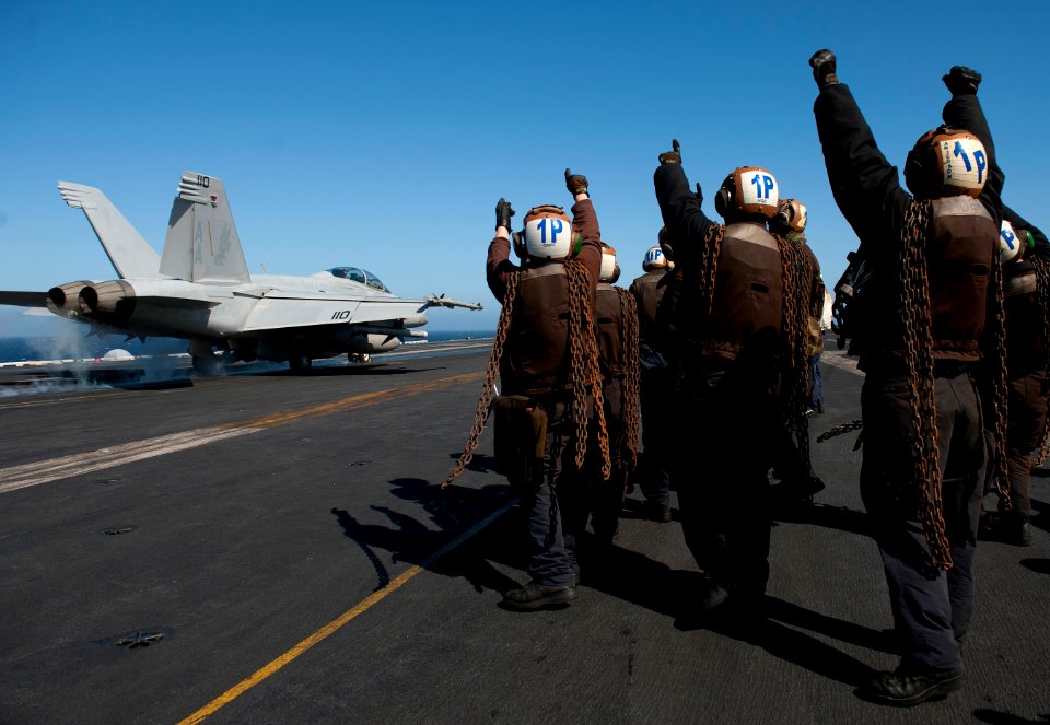 Flickr - Official U.S. Navy Imagery - Plane captains bid farewell to a launching F-A-18F Super Hornet.