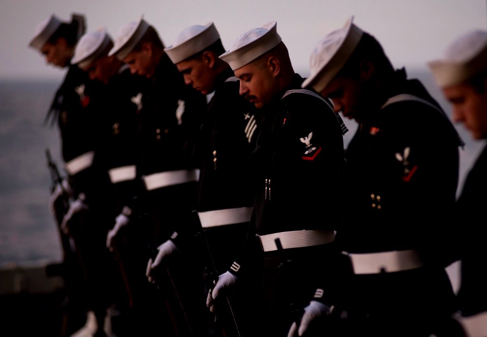 Flickr - Official U.S. Navy Imagery - Sailors assigned to the rifle detail bow their heads in prayer during a burial at sea