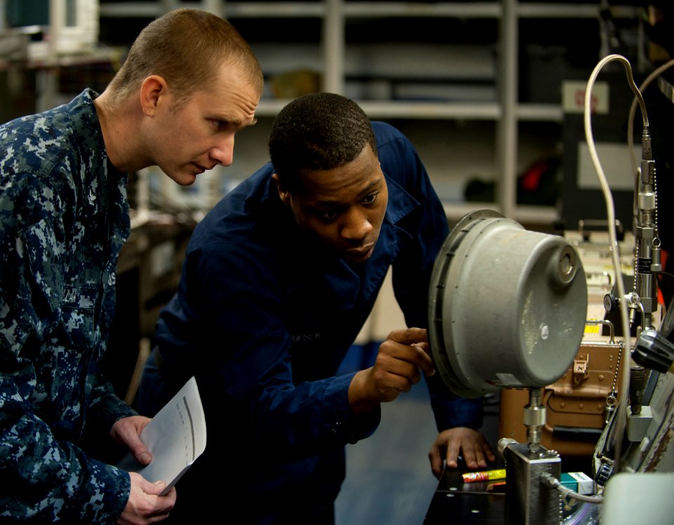 Flickr - Official U.S. Navy Imagery - Sailor discusses calibration of a pressure gauge with supervisor.