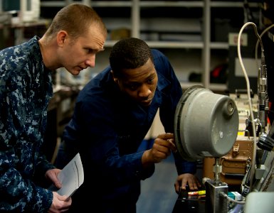 Flickr - Official U.S. Navy Imagery - Sailor discusses calibration of a pressure gauge with supervisor.