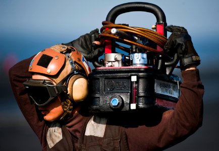 Flickr - Official U.S. Navy Imagery - Sailor carries hydraulic fluid to an aircraft aboard USS Carl Vinson.
