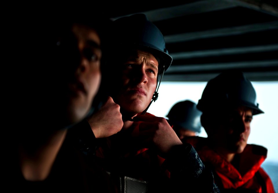 Flickr - Official U.S. Navy Imagery - Sailor fastens chin strap during man overboard drill.