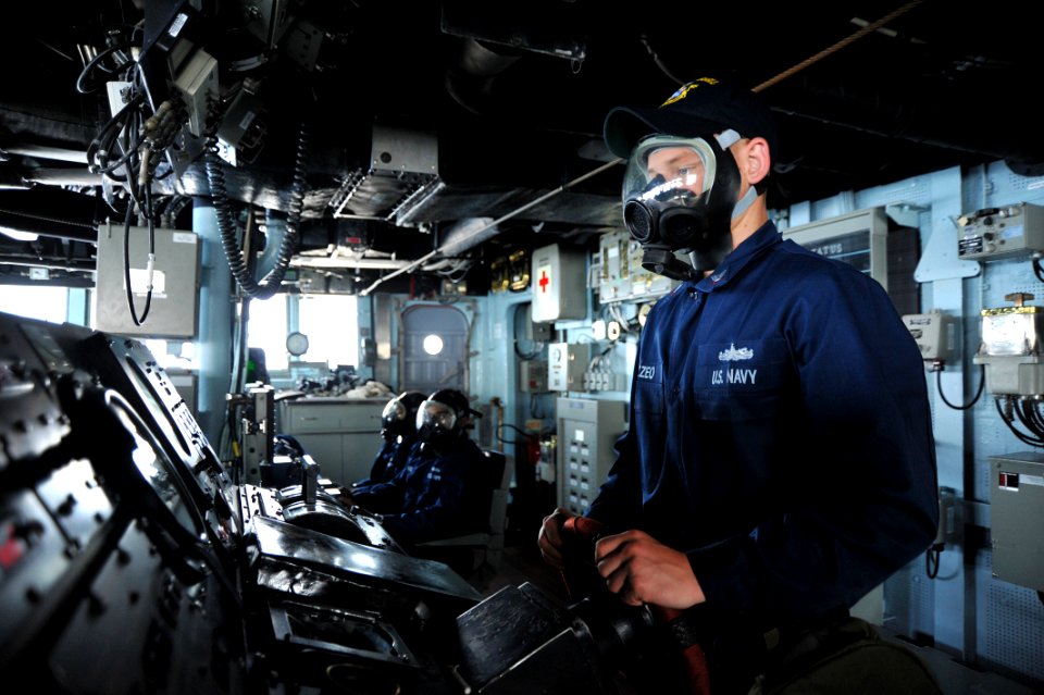 Flickr - Official U.S. Navy Imagery - Sailor drives the ship in a gas mask.