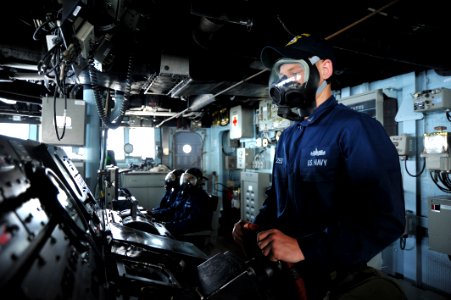 Flickr - Official U.S. Navy Imagery - Sailor drives the ship in a gas mask.