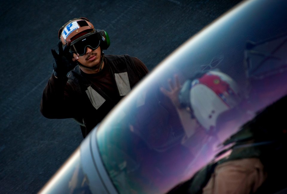 Flickr - Official U.S. Navy Imagery - Sailor communicates with Super Hornet pilot.