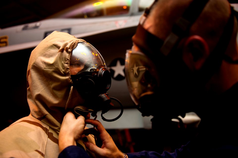 Flickr - Official U.S. Navy Imagery - Sailor helps another with protective garment.