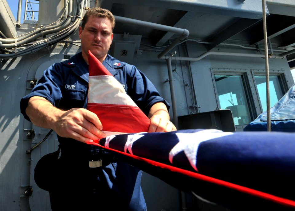 Flickr - Official U.S. Navy Imagery - Sailor folds the national ensign aboard USS Enterprise.