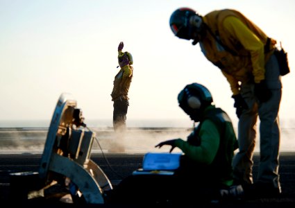 Flickr - Official U.S. Navy Imagery - Sailor directs aircraft onto bow catapults as it prepares to launch. photo