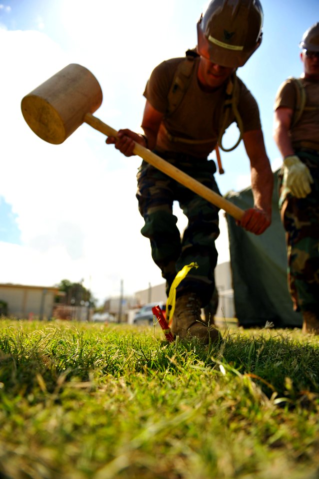 Flickr - Official U.S. Navy Imagery - Sailor hammers a stake in the ground during the timed field tent assembly at the annual Seabee Rodeo